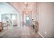 Elegant foyer with tile floors, stylish console table, and view into dining and living spaces at 3041 Cardillino Way, Kissimmee, FL 34741