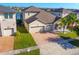 Attractive home with a three-car garage, well-maintained lawn, and inviting front entrance at 3041 Cardillino Way, Kissimmee, FL 34741