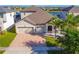 Charming home featuring a three-car garage, lush landscaping, and a welcoming entrance at 3041 Cardillino Way, Kissimmee, FL 34741