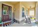 Welcoming front porch with rocking chairs, decorative wreath, and a cozy, inviting ambiance at 3041 Cardillino Way, Kissimmee, FL 34741