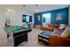 Large game room with pool table, oversized couch, and TV for relaxation and entertainment at 3041 Cardillino Way, Kissimmee, FL 34741