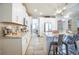 Bright kitchen with stainless steel appliances, granite counters, island with seating, and modern light fixtures at 3041 Cardillino Way, Kissimmee, FL 34741