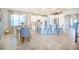 Open-concept kitchen and dining area with a large island, modern lighting, and bright, airy feel at 3041 Cardillino Way, Kissimmee, FL 34741
