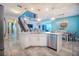 Bright open-concept kitchen with stainless steel appliances, granite counters, island with seating, and view to living area at 3041 Cardillino Way, Kissimmee, FL 34741