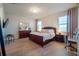 Spacious main bedroom with wood floors, dresser, and windows at 3041 Cardillino Way, Kissimmee, FL 34741