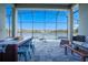 Enjoy the screened-in patio with stone flooring, a dining table, and access to the pool overlooking a scenic lake at 3041 Cardillino Way, Kissimmee, FL 34741