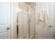 Glass-enclosed tiled shower in the bathroom of the home at 3041 Cardillino Way, Kissimmee, FL 34741