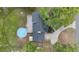Overhead view showing the home's roof, deck, above-ground pool, and surrounding yard at 30746 Fairview Ave, Tavares, FL 32778