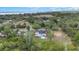 Stunning aerial view showcasing the home's backyard, deck, pool, and lush, wooded surroundings at 30746 Fairview Ave, Tavares, FL 32778