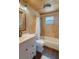 Bathroom featuring natural stone tile, white vanity and a shower with a tub at 30746 Fairview Ave, Tavares, FL 32778