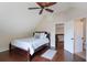 Well-lit bedroom with a ceiling fan, hardwood floors, and an ensuite bathroom at 30746 Fairview Ave, Tavares, FL 32778