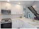 Bright kitchen with white cabinets, stainless steel appliances, and quartz countertops at 30746 Fairview Ave, Tavares, FL 32778
