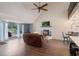 Comfortable living room with a fireplace, large windows, vaulted ceiling, and hardwood floors at 30746 Fairview Ave, Tavares, FL 32778