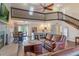 Cozy living room with a stone fireplace, hardwood floors, and a beautiful view from the large windows at 30746 Fairview Ave, Tavares, FL 32778