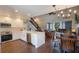 Open floor plan featuring a modern kitchen and living room with an adjacent dining area under a stylish chandelier at 30746 Fairview Ave, Tavares, FL 32778