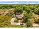 An aerial view of the home's surrounding landscape with lush greenery, a detached garage and ample parking at 3137 East St, Oviedo, FL 32765