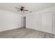 Bedroom featuring wood-look floors and double closets for ample storage at 3137 East St, Oviedo, FL 32765
