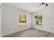 Bedroom with neutral walls, laminate flooring and natural light from two windows at 3137 East St, Oviedo, FL 32765