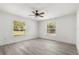 Cozy bedroom with wood-look flooring, neutral walls and bright windows at 3137 East St, Oviedo, FL 32765
