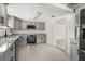 Updated kitchen with gray cabinetry, granite countertops, stainless steel appliances, and tile flooring at 3137 East St, Oviedo, FL 32765