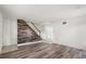 Spacious living room with wood-look floors, staircase with wood accents, and a decorative wood paneled wall at 3137 East St, Oviedo, FL 32765
