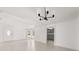 Bright living room featuring an elegant chandelier, white walls and tile floors at 3137 East St, Oviedo, FL 32765