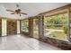 Enclosed brick sunroom offering ample natural light through large windows, tile flooring, and security door at 3137 East St, Oviedo, FL 32765