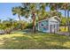 The backyard features a storage shed, palm trees and a trampoline at 3216 John Anderson Dr, Ormond Beach, FL 32176