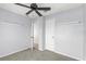 A bedroom with light blue walls, a ceiling fan, and two closets at 3216 John Anderson Dr, Ormond Beach, FL 32176