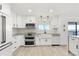 A kitchen boasts white cabinetry, stainless steel appliances, and an island with a stone countertop at 3216 John Anderson Dr, Ormond Beach, FL 32176