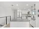 Modern kitchen with white cabinets, island, and stainless steel appliances at 3216 John Anderson Dr, Ormond Beach, FL 32176