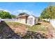 A view of the backyard of the property, with a utility shed and plenty of lawn at 4705 Beggs Rd, Orlando, FL 32810