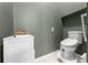Bathroom featuring modern toilet, small vanity, and green walls at 4705 Beggs Rd, Orlando, FL 32810