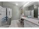 Bathroom with a glass-enclosed shower, a vanity with storage, and neutral tile flooring at 4705 Beggs Rd, Orlando, FL 32810