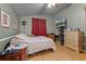 Bedroom with a view of TV, light walls, and a cozy bed at 4705 Beggs Rd, Orlando, FL 32810