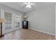 A bedroom with tiled floors, ceiling fan and French doors with views to the exterior at 4705 Beggs Rd, Orlando, FL 32810