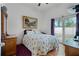 Bedroom with hardwood floors, a sliding glass door, and a cozy bed at 4705 Beggs Rd, Orlando, FL 32810
