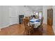 Open dining room with hardwood floors, dining table, and an adjacent doorway at 4705 Beggs Rd, Orlando, FL 32810