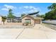 Charming home exterior with an attached garage, a well-manicured lawn, and an inviting entrance at 4705 Beggs Rd, Orlando, FL 32810