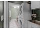 Efficient laundry room with a stacked washer and dryer, utility sink, and ample storage space at 4705 Beggs Rd, Orlando, FL 32810