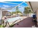 A covered and screened in pool featuring a spa and room for patio furniture at 4705 Beggs Rd, Orlando, FL 32810