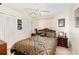 Inviting bedroom with a ceiling fan, closet, and a queen bed adorned with decorative pillows and comforter at 4723 Cherokee Rose Dr, Orlando, FL 32808