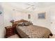 Bright bedroom featuring a fan, queen bed, and side tables, creating a relaxing and comfortable space at 4723 Cherokee Rose Dr, Orlando, FL 32808