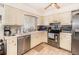 Functional kitchen with stainless steel appliances, tile floors, and ample counter space at 4723 Cherokee Rose Dr, Orlando, FL 32808