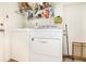 Laundry room with white washer and dryer, wire shelving and a white door at 4723 Cherokee Rose Dr, Orlando, FL 32808