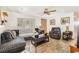 Cozy living room featuring tile floors, a ceiling fan, and abundant natural light at 4723 Cherokee Rose Dr, Orlando, FL 32808