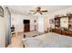 Bright main bedroom features a ceiling fan, dresser with television, and an open doorway leading to another room at 4723 Cherokee Rose Dr, Orlando, FL 32808