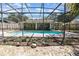 Backyard with a screened pool and view of the home from outside of the enclosure at 4723 Cherokee Rose Dr, Orlando, FL 32808
