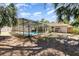 Screened-in pool area in a backyard with mature trees and a cozy atmosphere at 4723 Cherokee Rose Dr, Orlando, FL 32808