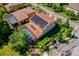 Expansive aerial view of a home with a screened pool, solar panels, and well-maintained landscaping at 4932 Eastlake Vista Dr, St Cloud, FL 34771